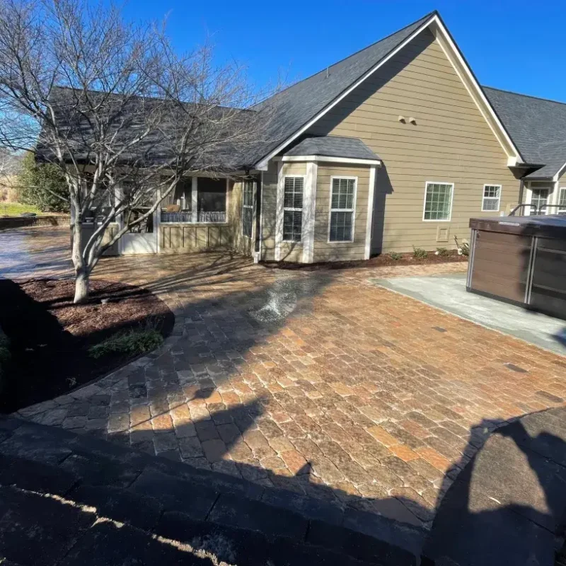 Huge cobblestone paver patio by Quiett Scapes