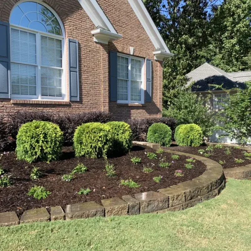 Front yard landscape design by Quiett Scapes complete with planes and retaining wall